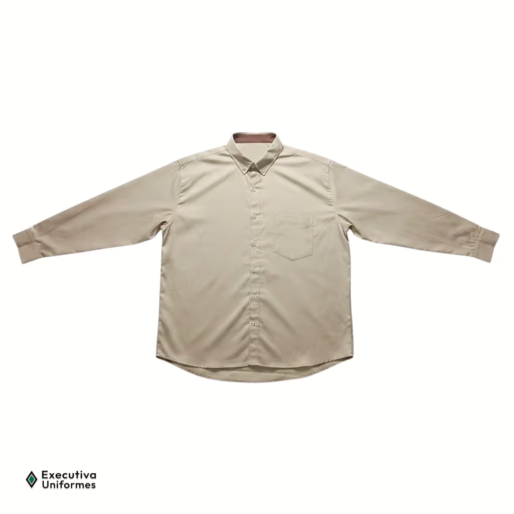 Camisa social liso de manga longa na cor bege. Possui modelagem tradicional, fechamento frontal por botões claros, gola com botões de fixação nas pontas (estilo button-down) contendo um detalhe interno em tecido marrom escuro, e um bolso simples no lado esquerdo do peito.